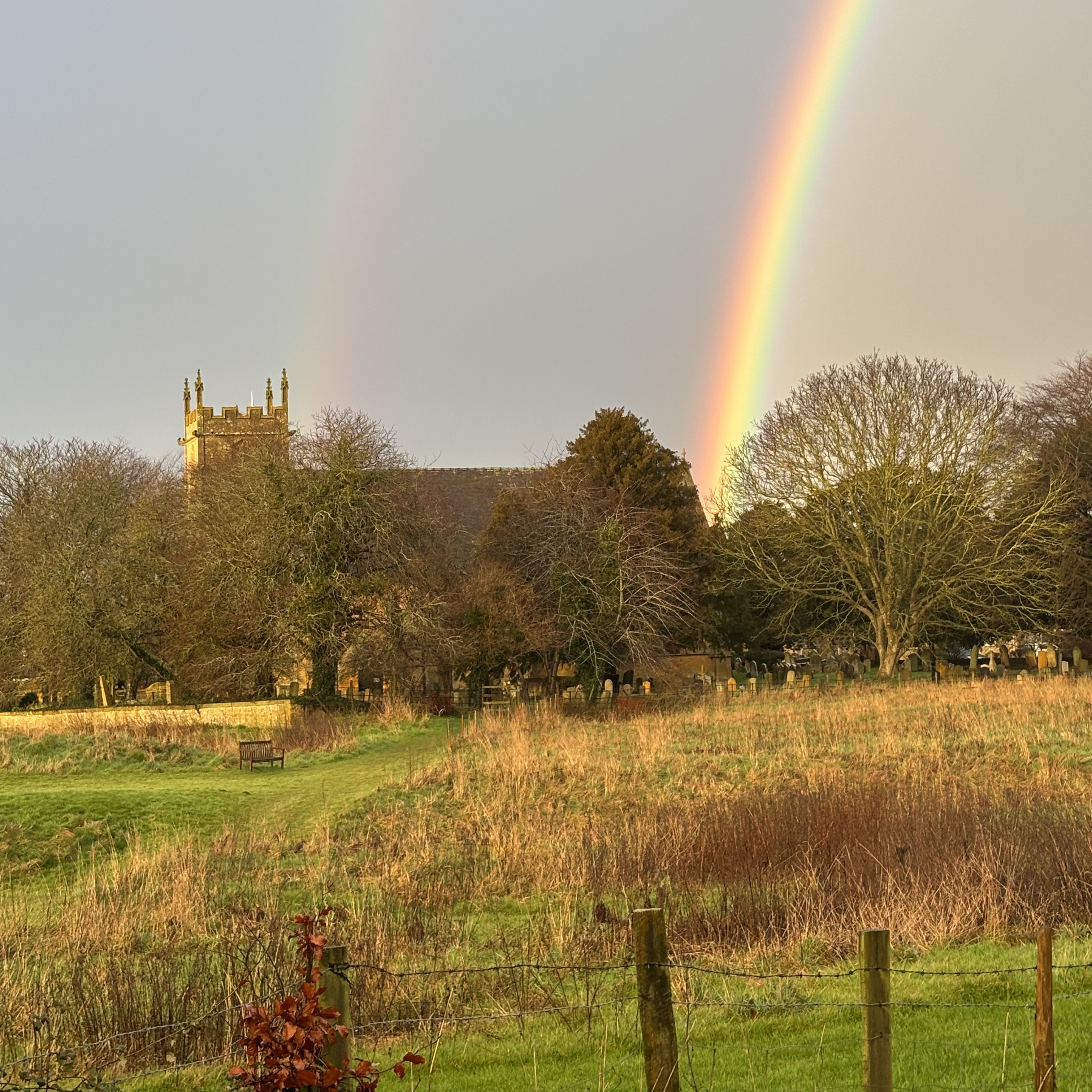 The Norman church at Weston-sub-Edge with a rainbow