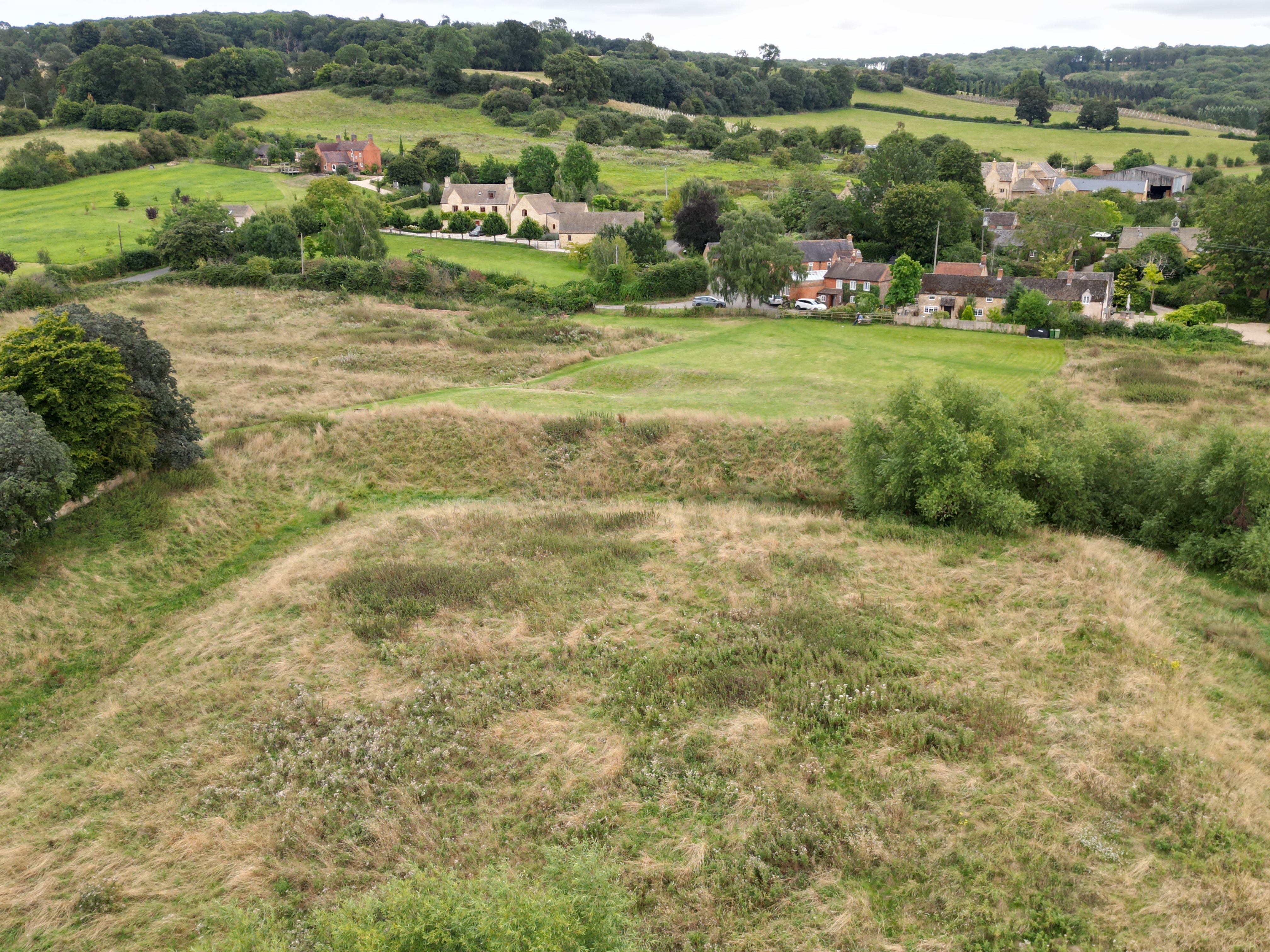 Weston-sub-Edge heritage site showing the medieval moat, fishponds and adjacent Norman church